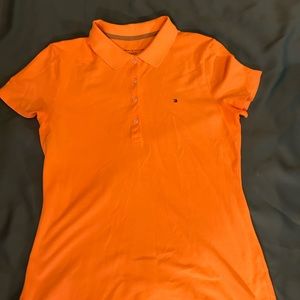 Classic orange Tommy Hilfiger polo style shirt.